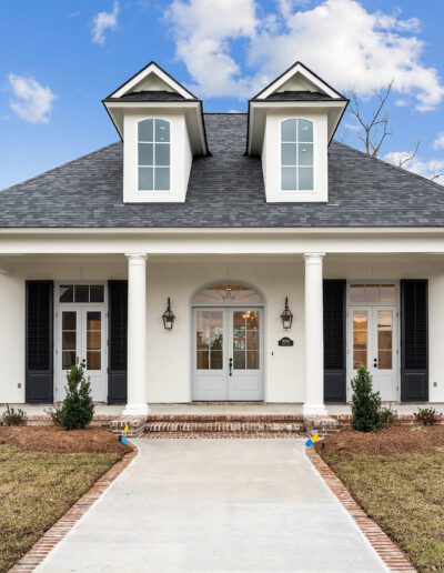 New suburban home with symmetrical design and a central entrance pathway.