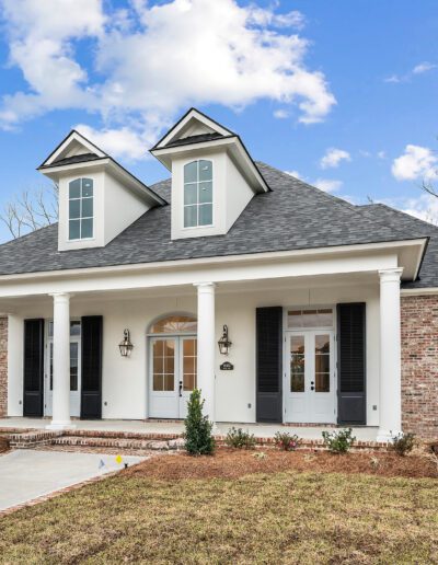 New suburban house with a gabled roof and a covered front porch.