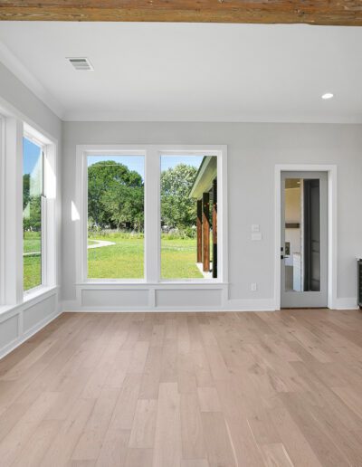 Bright, modern living space with large windows and an open kitchen design.