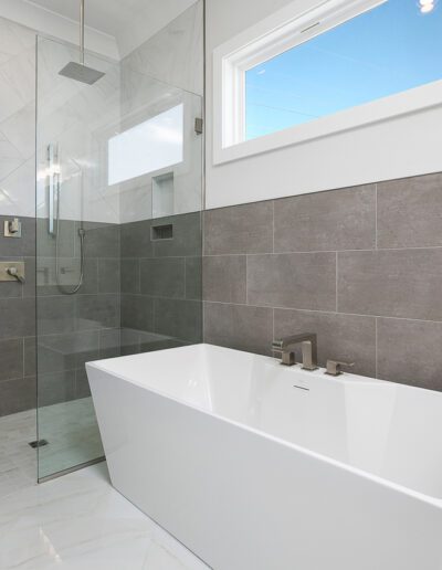 Modern bathroom with a freestanding tub and a walk-in shower with glass doors.