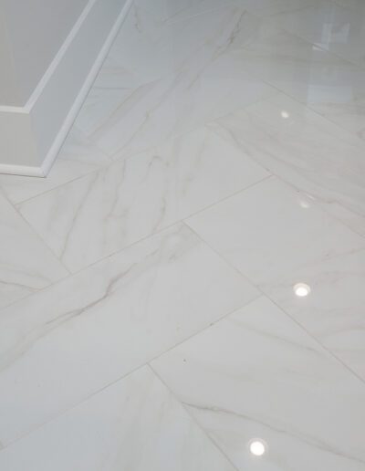 Modern room corner with white marble flooring.