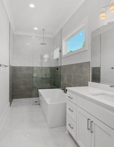 Modern bathroom with double vanity and walk-in shower.