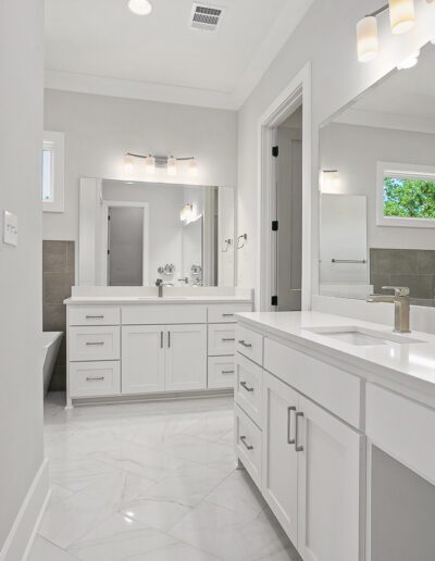Modern bathroom interior with double vanity and large mirror.