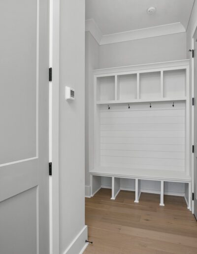 A clean, empty hallway with a built-in bench and storage cubbies.