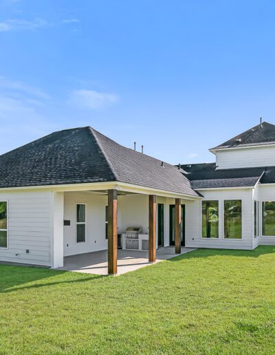 New suburban single-story home with a dark roof and white trim.